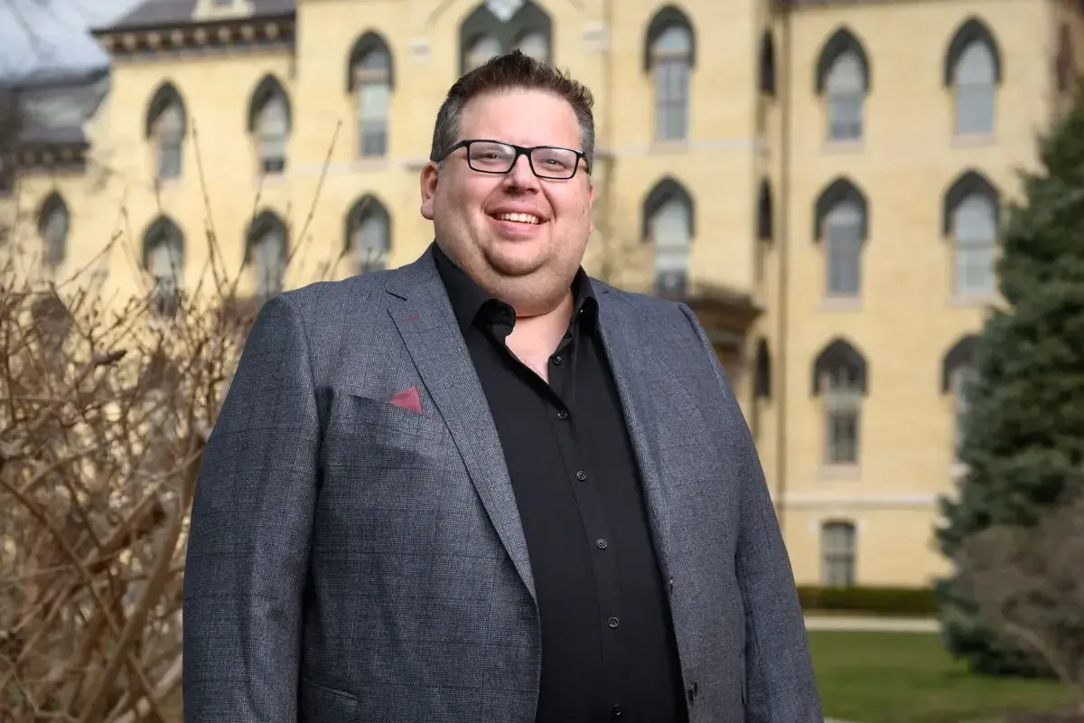 A portrait of Jeff Rhoads standing in front of the Notre Dame Administration building